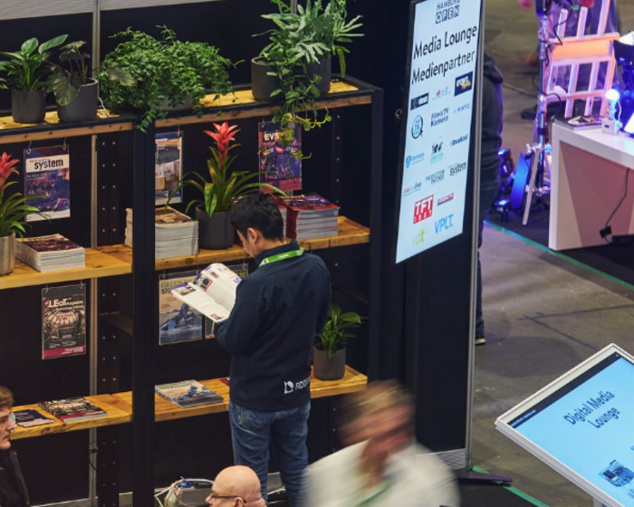 [Translate to EN:] Ein Mann steht am Zeitschriftenregal der Media Lounge.